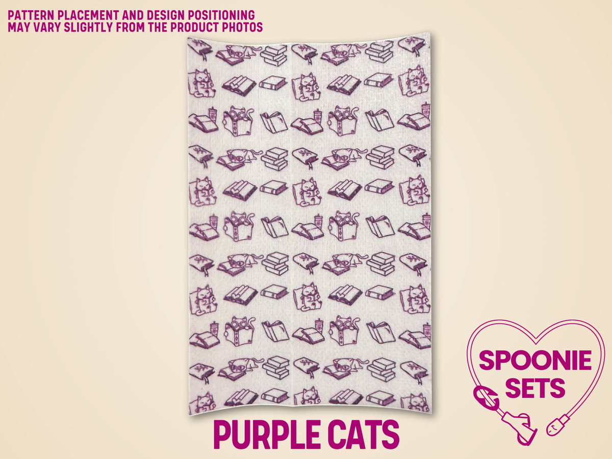 White Hypafix tubie tape with a repeating pattern of purple cats and books.