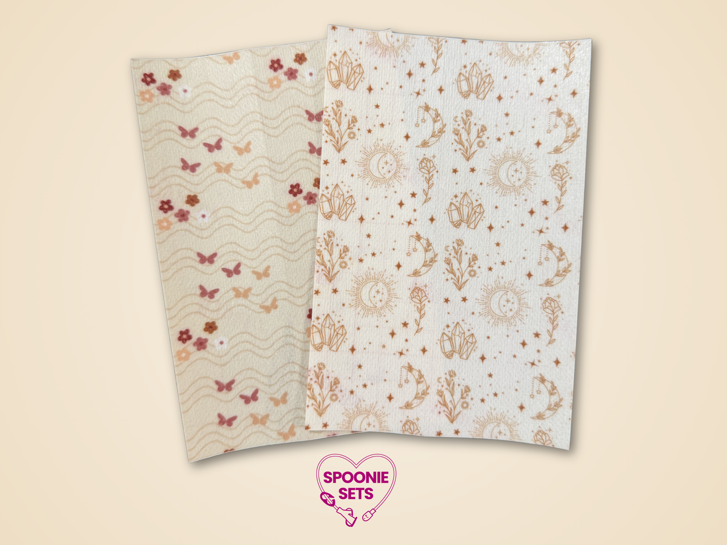 Two sheets of Hypafix tape: brown crystals on a white background and butterflies and flowers on a cream background.