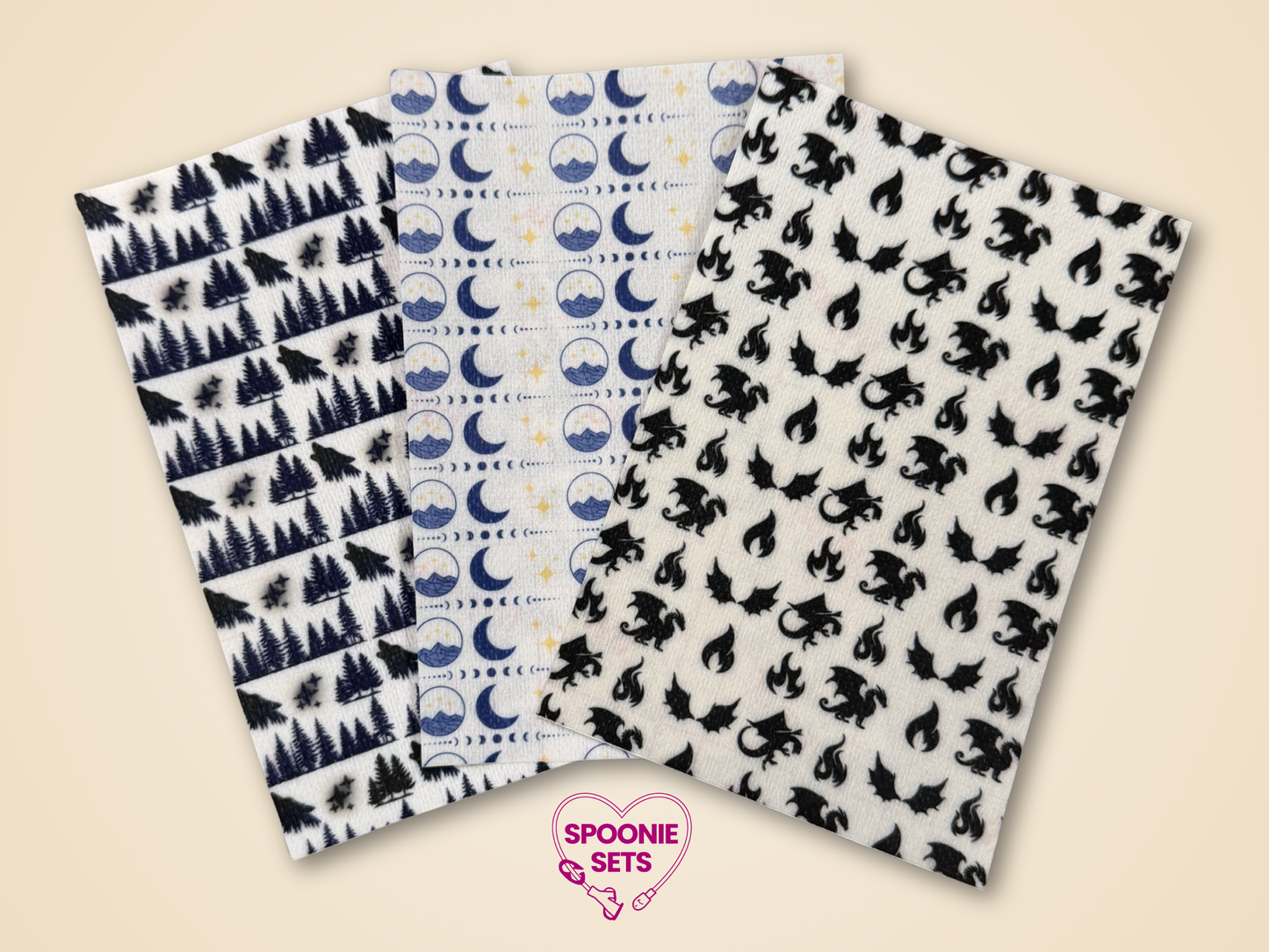 Three sheets of decorative Hypafix tubie tape with forest, moon/wave, and dragon designs.