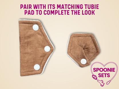 Two brown pads with white buttons on a beige background, featuring text and a brand logo.