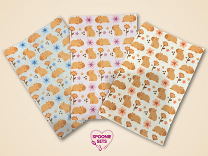 Three sheets of decorative Hypafix tubie tape featuring a capybara and floral pattern in blue, pink, and cream.