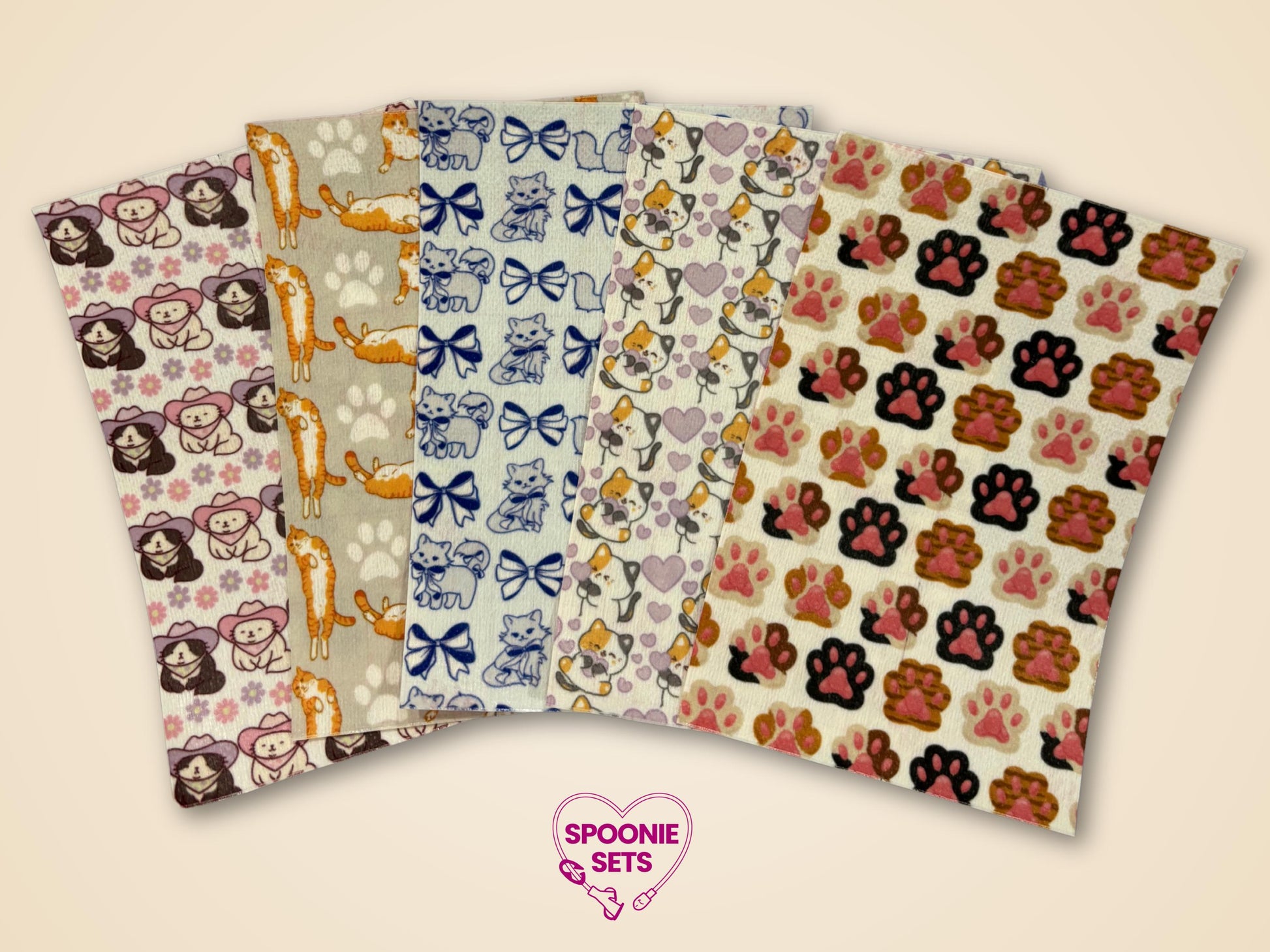 Six sheets of decorative Hypafix tubie tape with cat, bow, cowboy hat, and paw print designs.