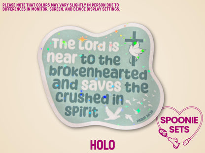 Holographic Christian sticker with green background, white doves, and "The Lord is near to the brokenhearted" text.