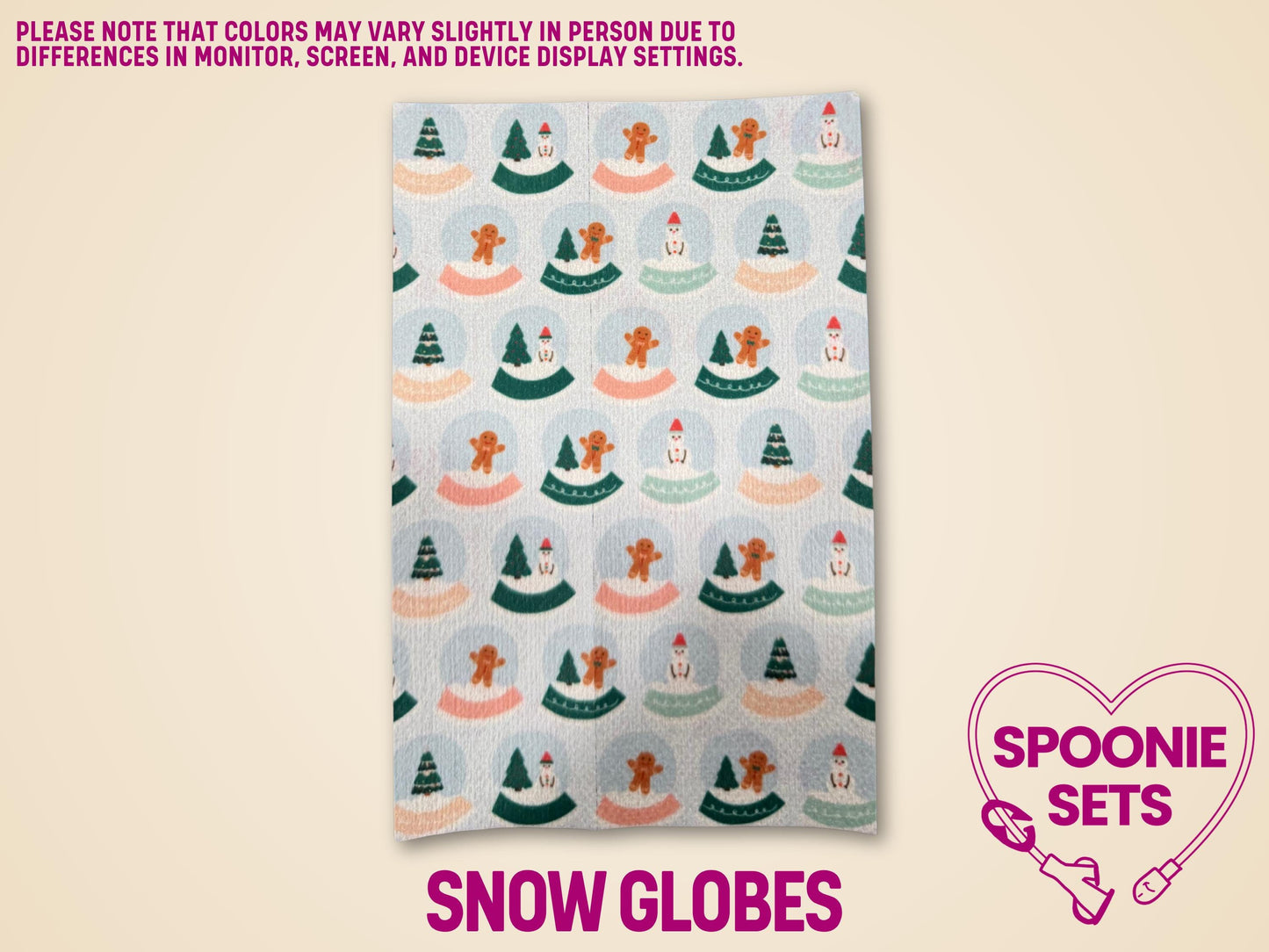 Festive Hypafix tubie tape sheet with a repeating pattern of snow globes featuring gingerbread men and trees.