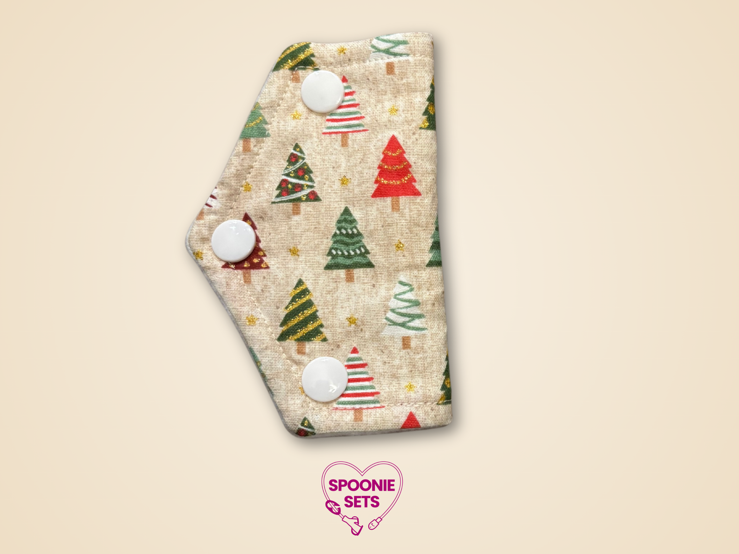 Patterned product with Christmas tree design on a beige background, featuring the brand 'Spoonie Sets'.