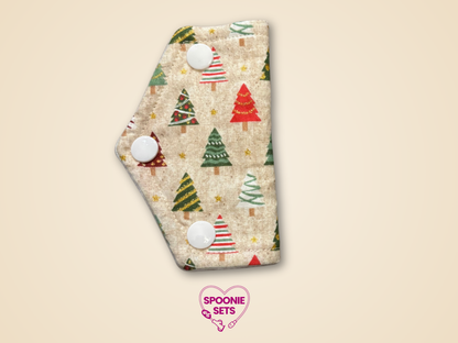 Patterned product with Christmas tree design on a beige background, featuring the brand 'Spoonie Sets'.