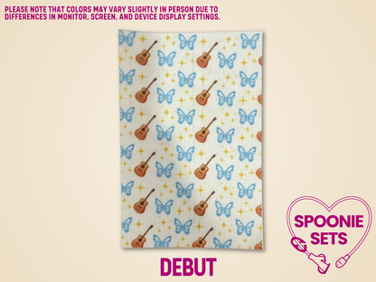 Hypafix tubie tape with blue butterflies and brown guitars on a white background.