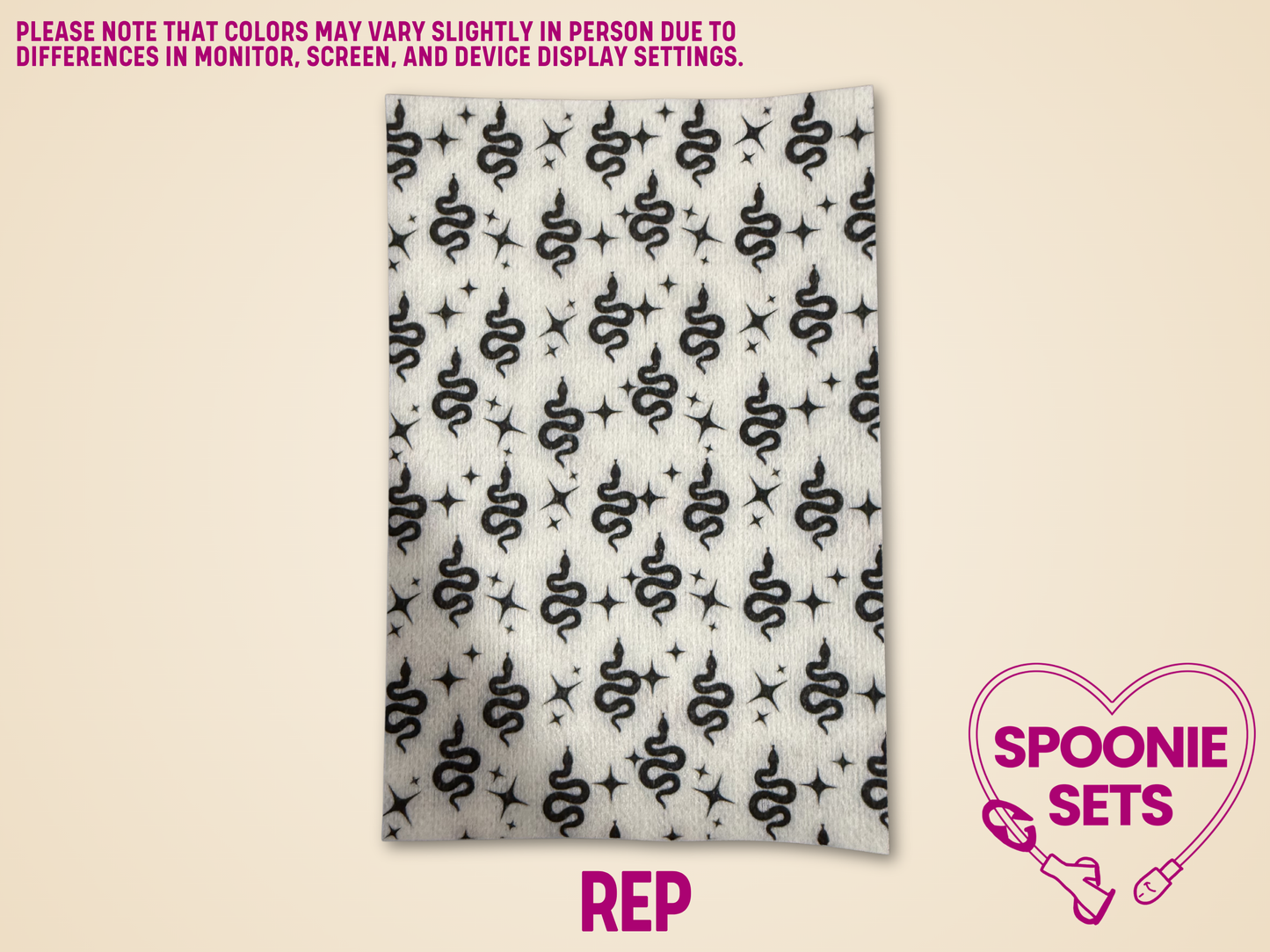 Decorative Hypafix tubie tape with black snakes and stars on a light background.