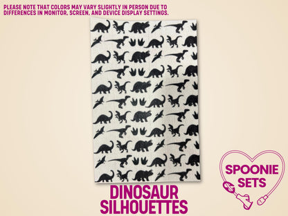 White Hypafix tubie tape sheet with black dinosaur silhouettes, for decorative medical device personalization.