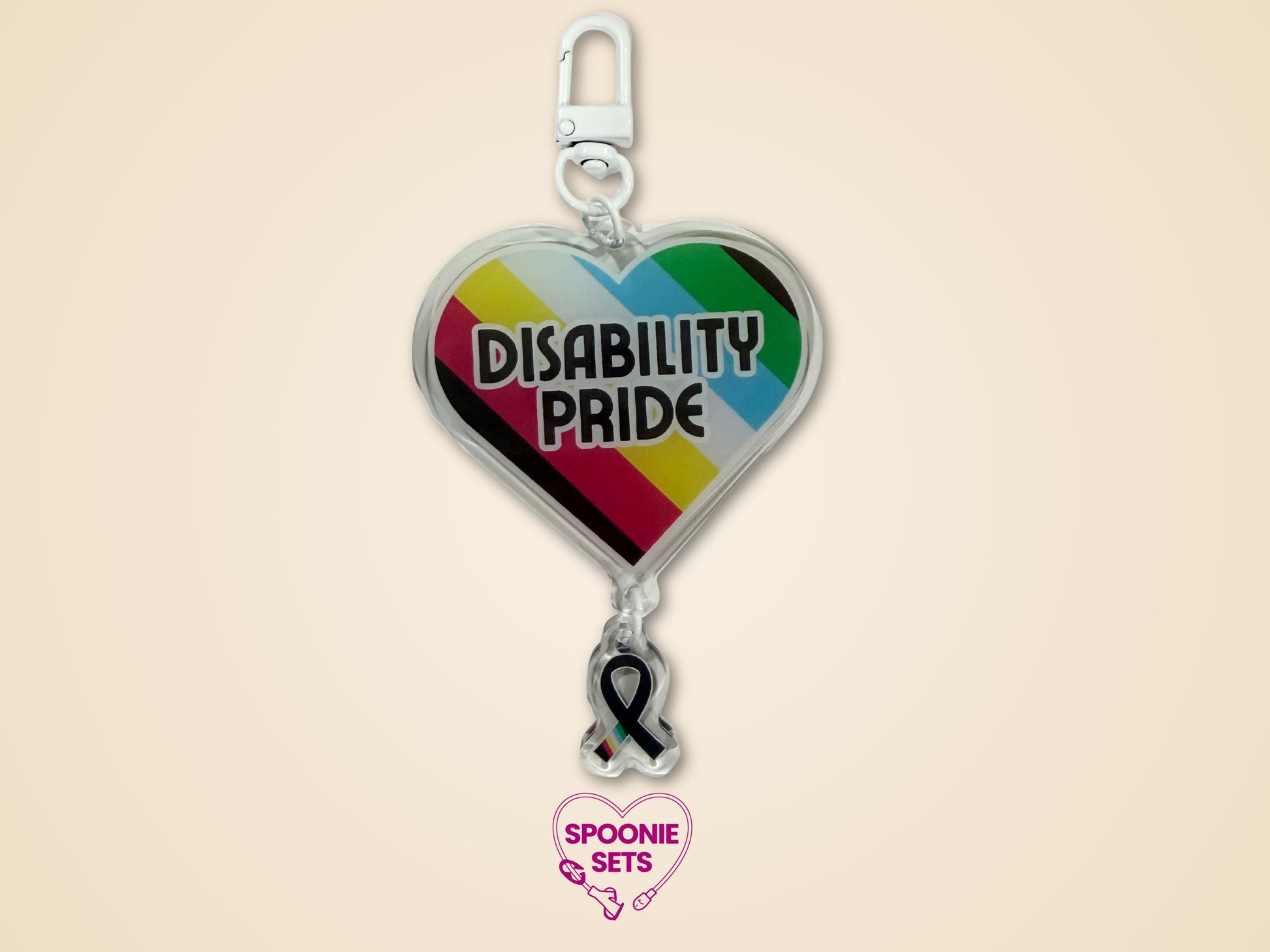 Acrylic heart keychain with "DISABILITY PRIDE" text and disability flag colors, linked to a black awareness ribbon.