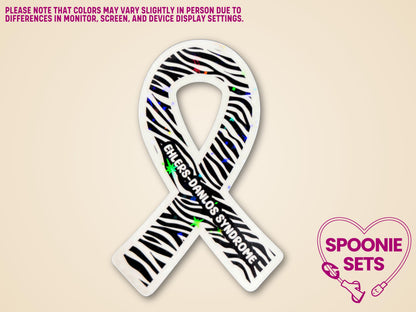 Zebra print awareness ribbon sticker with "Ehlers-Danlos Syndrome" text and holographic glitter laminate.