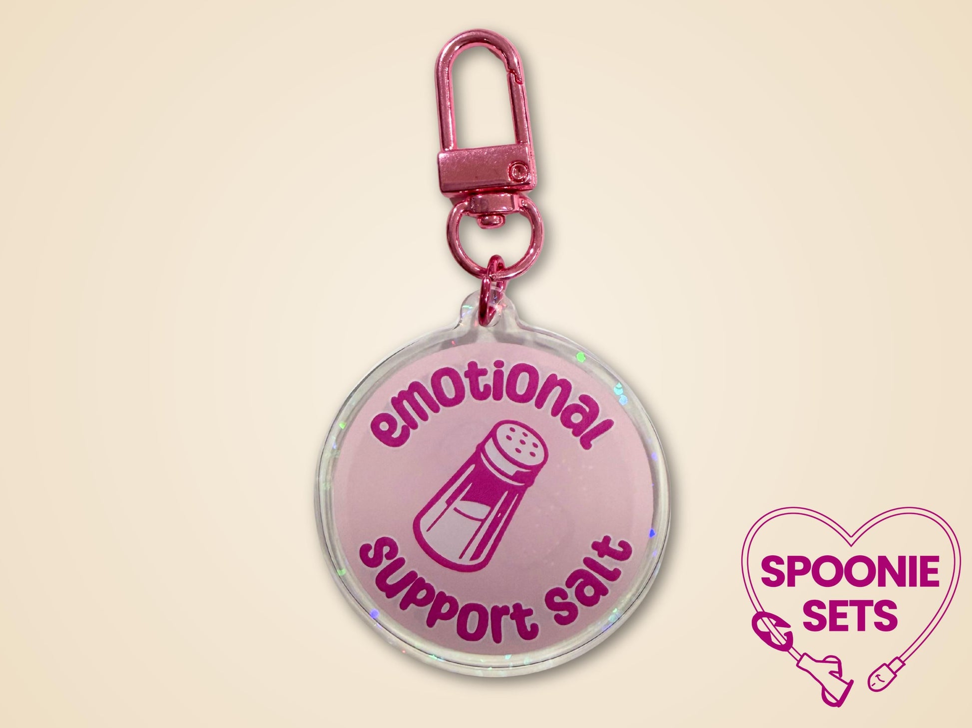 Pink holographic acrylic keychain with "Emotional Support Salt" text and a salt shaker design.