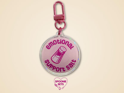 Pink holographic acrylic keychain with "Emotional Support Salt" text and a salt shaker design.