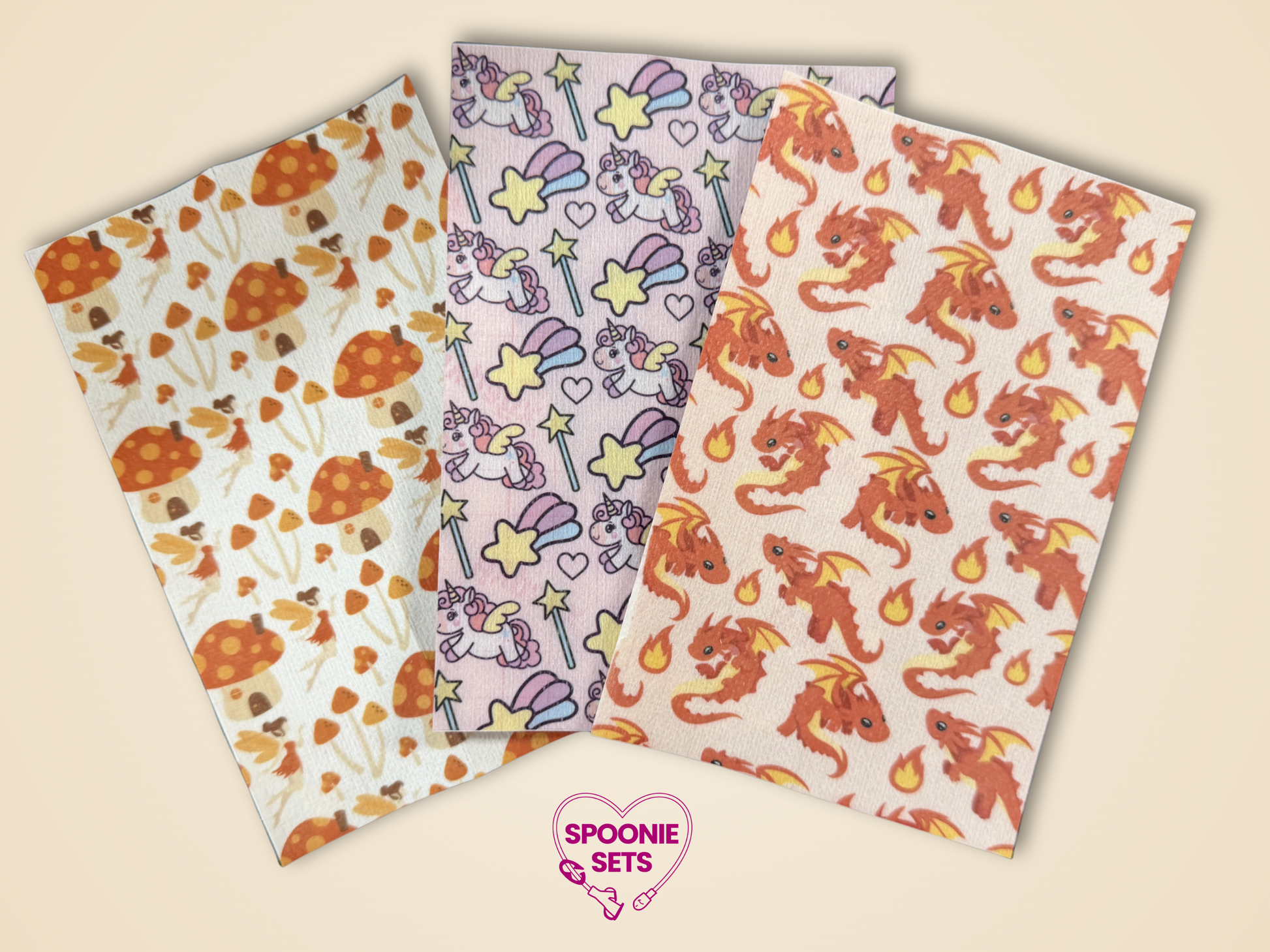Three sheets of decorative Hypafix tubie tape: mushroom, dragon, and unicorn designs.