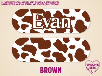 Brown cow print feeding tube pump sticker with "Evan" in white, and a blank matching sticker.