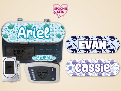 Sea life feeding tube pump stickers: green turtles for "Ariel," blue sharks for "Evan," and purple octopuses for "Cassie.