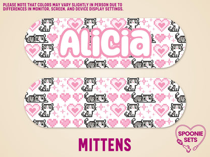 Two white matte feeding tube pump stickers with pixel art gray cats and pink hearts. One sticker features the name "Alicia.