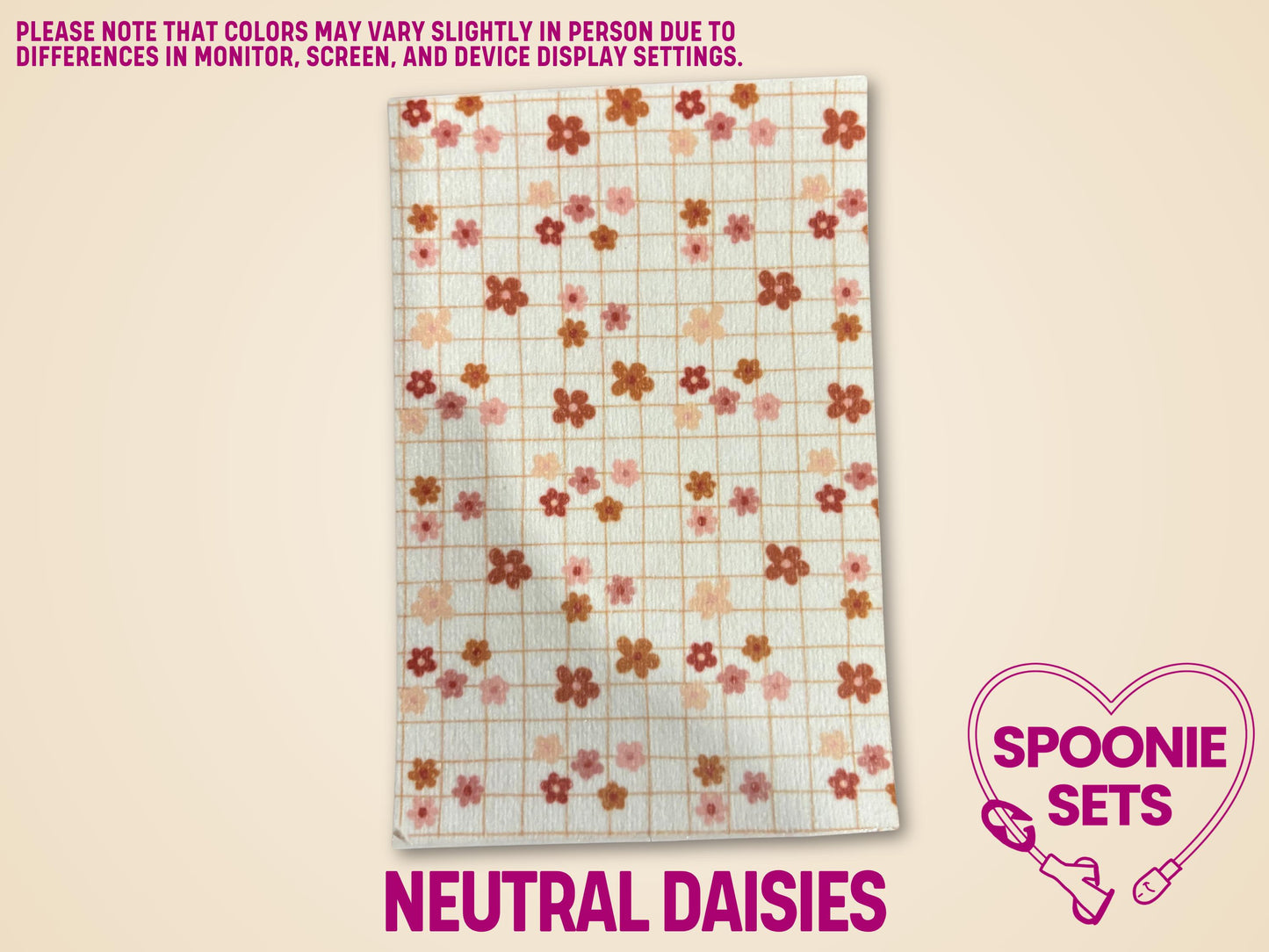 White Hypafix tubie tape sheet with a neutral grid pattern and scattered pink, orange, and brown daisy flowers.