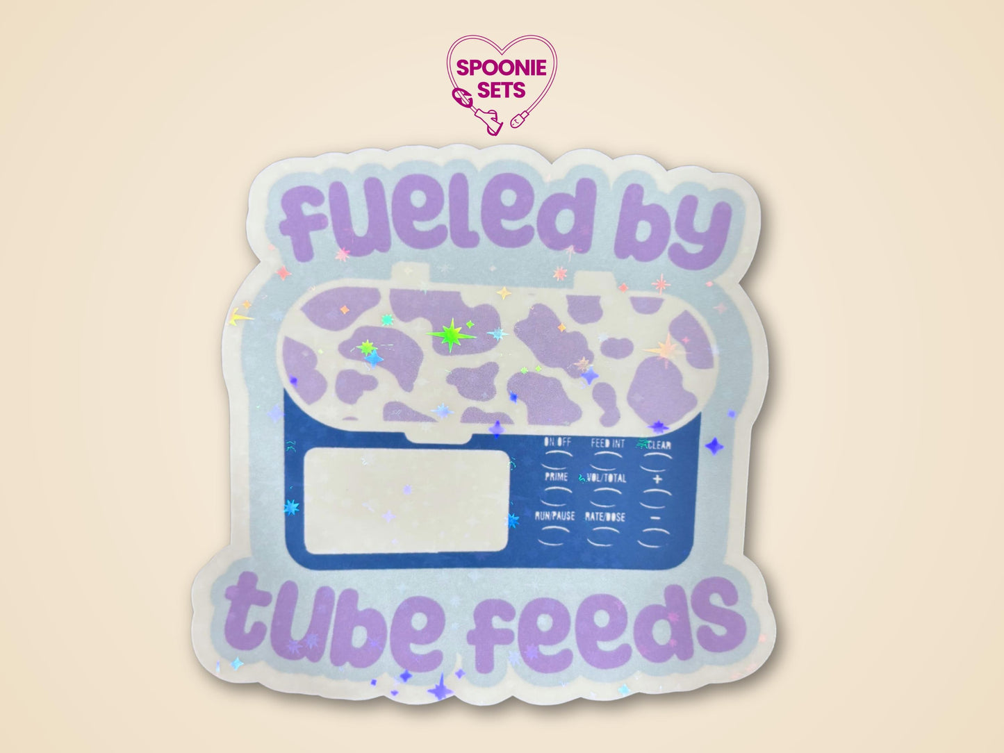Holographic "Fueled by Tube Feeds" sticker featuring a purple cow-print feeding tube pump on a light blue background.