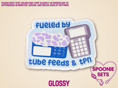 Holographic sticker with "Fueled by Tube Feeds & TPN" text, featuring a purple cow print feeding tube pump and TPN pump.