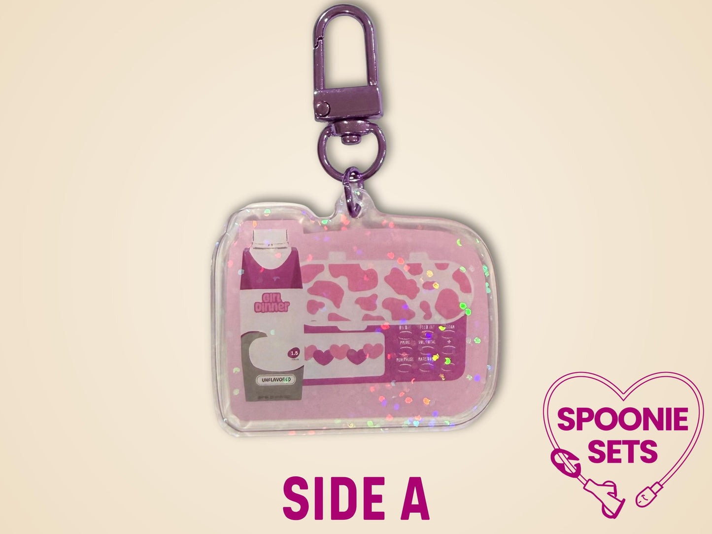 Pink acrylic keychain with "Girl Dinner" feeding tube pump and formula bottle design, holographic dot overlay.