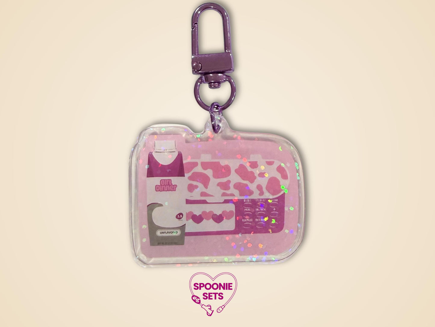 Pink "Girl Dinner" acrylic keychain with feeding tube pump and formula bottle design, holographic dot overlay.