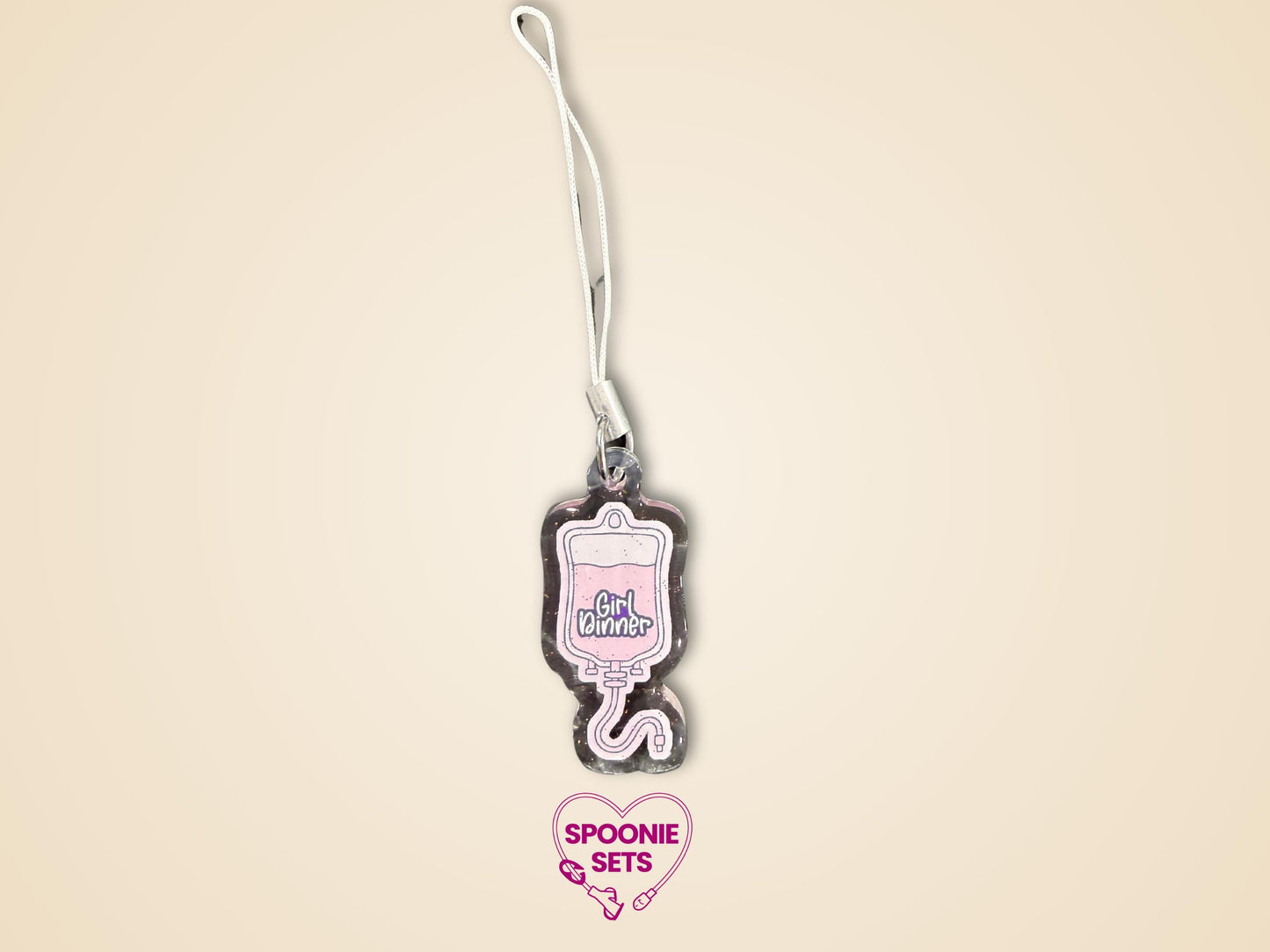 Pink TPN bag acrylic keychain with "Girl Dinner" text, glitter epoxy finish, and white strap.