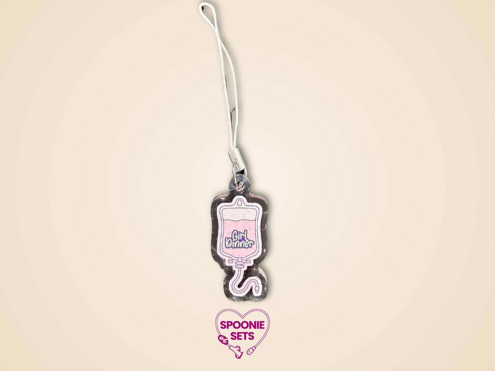 Pink TPN bag acrylic keychain with "Girl Dinner" text, glitter epoxy finish, and white strap.