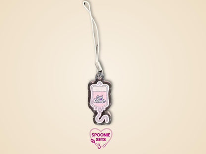 Pink TPN bag acrylic keychain with "Girl Dinner" text, glitter epoxy finish, and white strap.