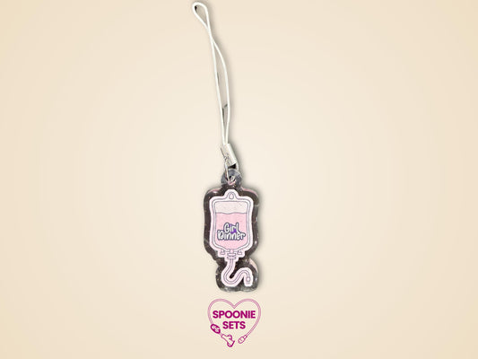 Pink TPN bag acrylic keychain with "Girl Dinner" text, glitter epoxy finish, and white strap.