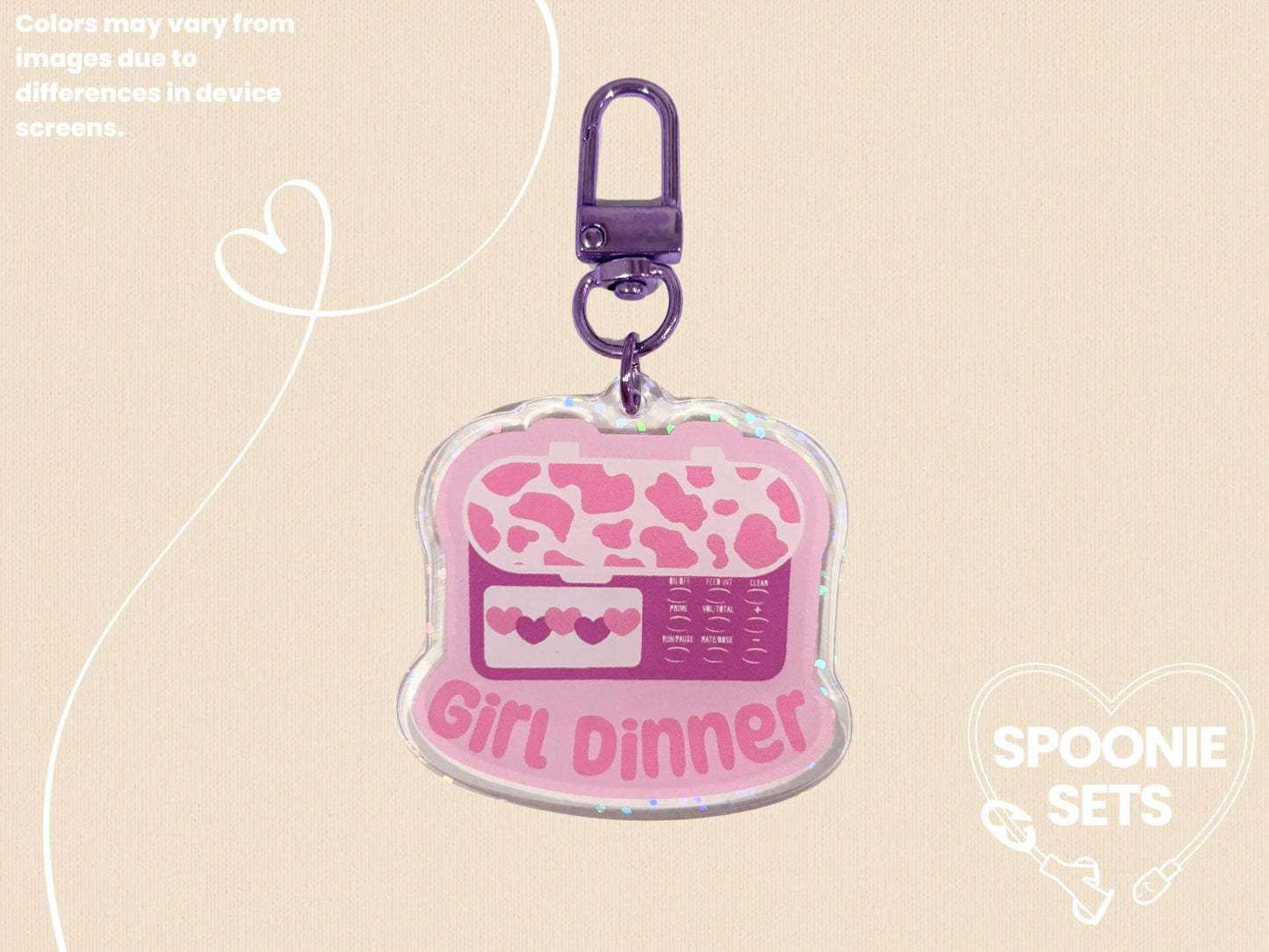 Pink acrylic keychain with a feeding tube pump design, "Girl Dinner" text, and holographic dot overlay.