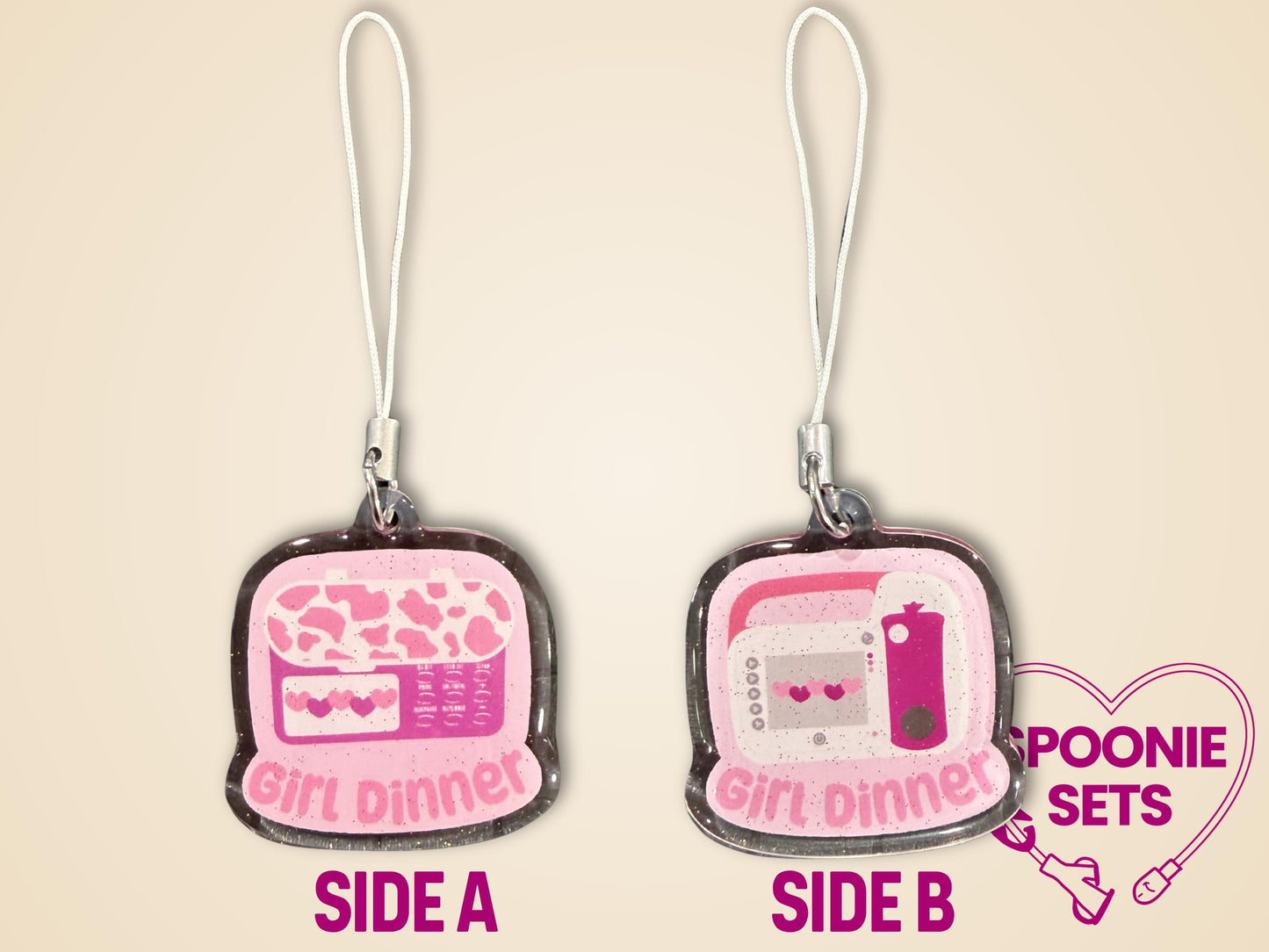Pink glitter epoxy acrylic phone charm with "Girl Dinner" and a feeding tube pump design.