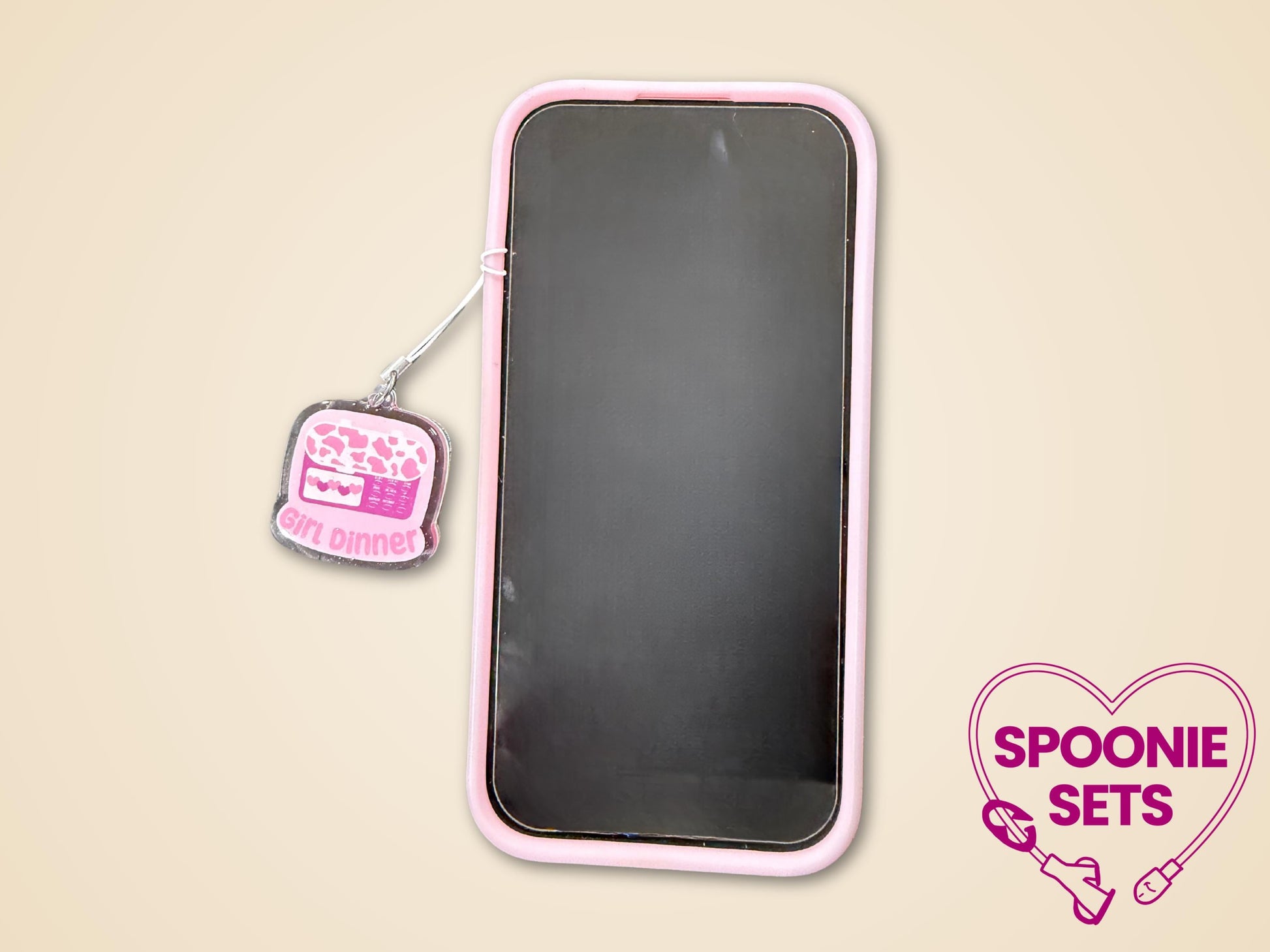 Pink "Girl Dinner" feeding tube pump acrylic phone charm with glitter epoxy finish, attached to a phone.