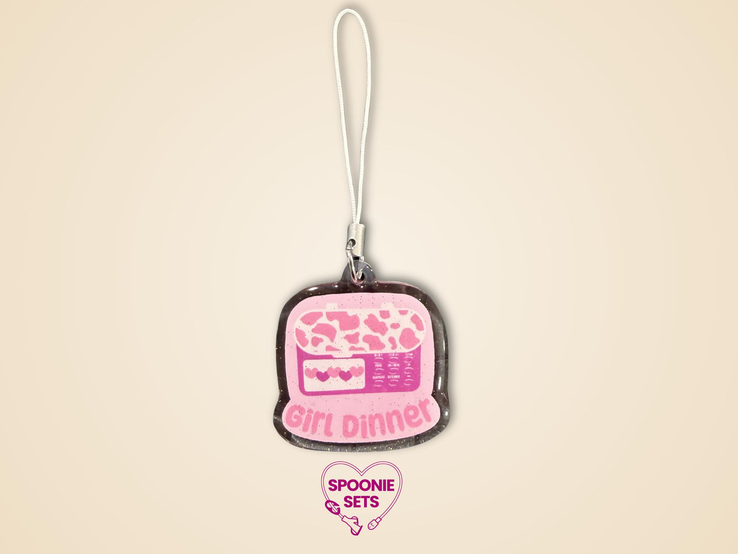 Pink glitter epoxy acrylic phone charm with "Girl Dinner" and a feeding tube pump design.
