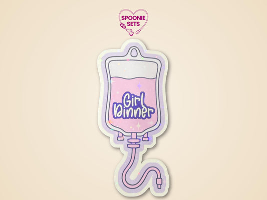 Holographic glitter sticker of a purple TPN bag with pink liquid and "Girl Dinner" text.