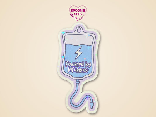 Holographic glitter sticker of a blue IV fluid bag with "Powered by Infusions" text on a purple background.