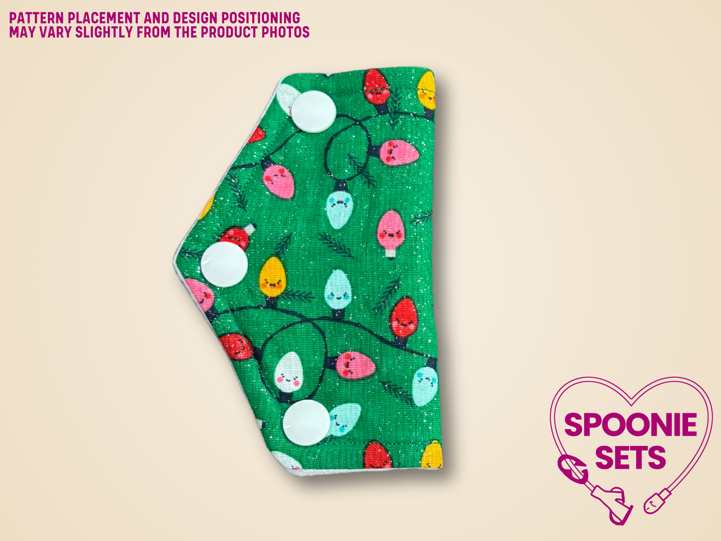 port cover with Christmas lights design on a beige background, featuring the brand 'Spoonie Sets'.