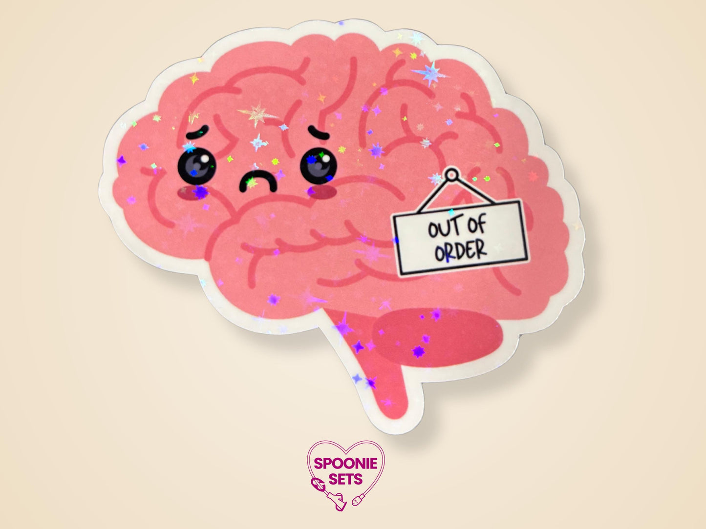 Pink brain sticker with a frowning face and an "Out of Order" sign, featuring a holographic glitter laminate finish.