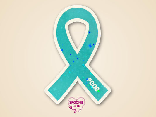Teal PCOS awareness ribbon sticker with "PCOS" text, holographic glitter finish, and a white border.