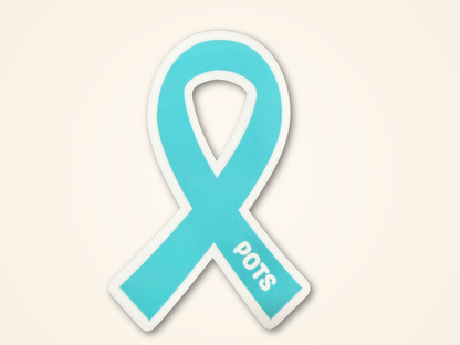A light blue awareness ribbon sticker with a white border and the text 'POTS' printed on the lower right arm, shown on a plain off-white background.