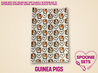 White Hypafix tubie tape with a repeating pattern of guinea pig faces and black outline hearts.