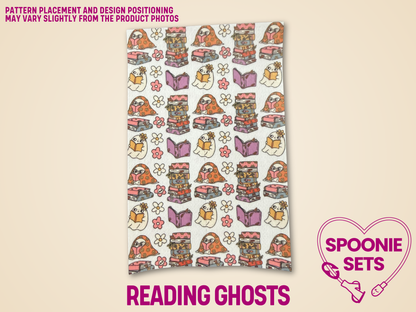 White Hypafix tubie tape with a repeating pattern of cartoon ghosts reading books, floral stacks of books, and flowers.