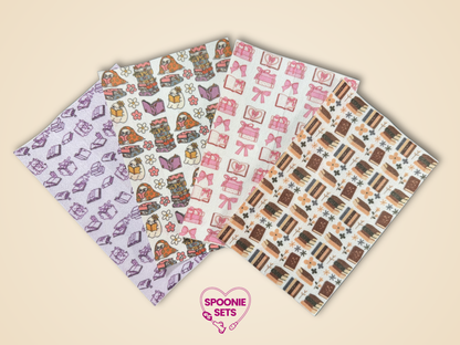 Four sheets of Hypafix tubie tape: pink bows, floral library with cats, and brown book stacks.
