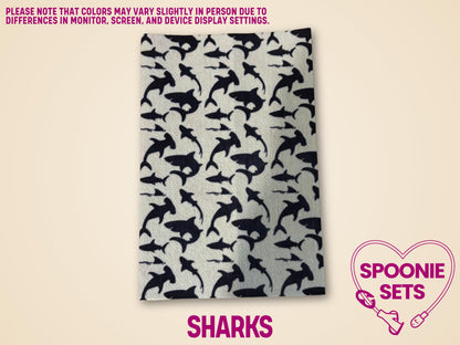 White Hypafix tubie tape sheet with a repeating pattern of black shark silhouettes.