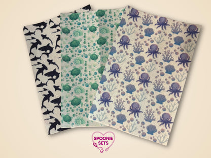 Three sheets of decorative Hypafix tubie tape: black sharks, green turtles, and purple octopuses with shells.