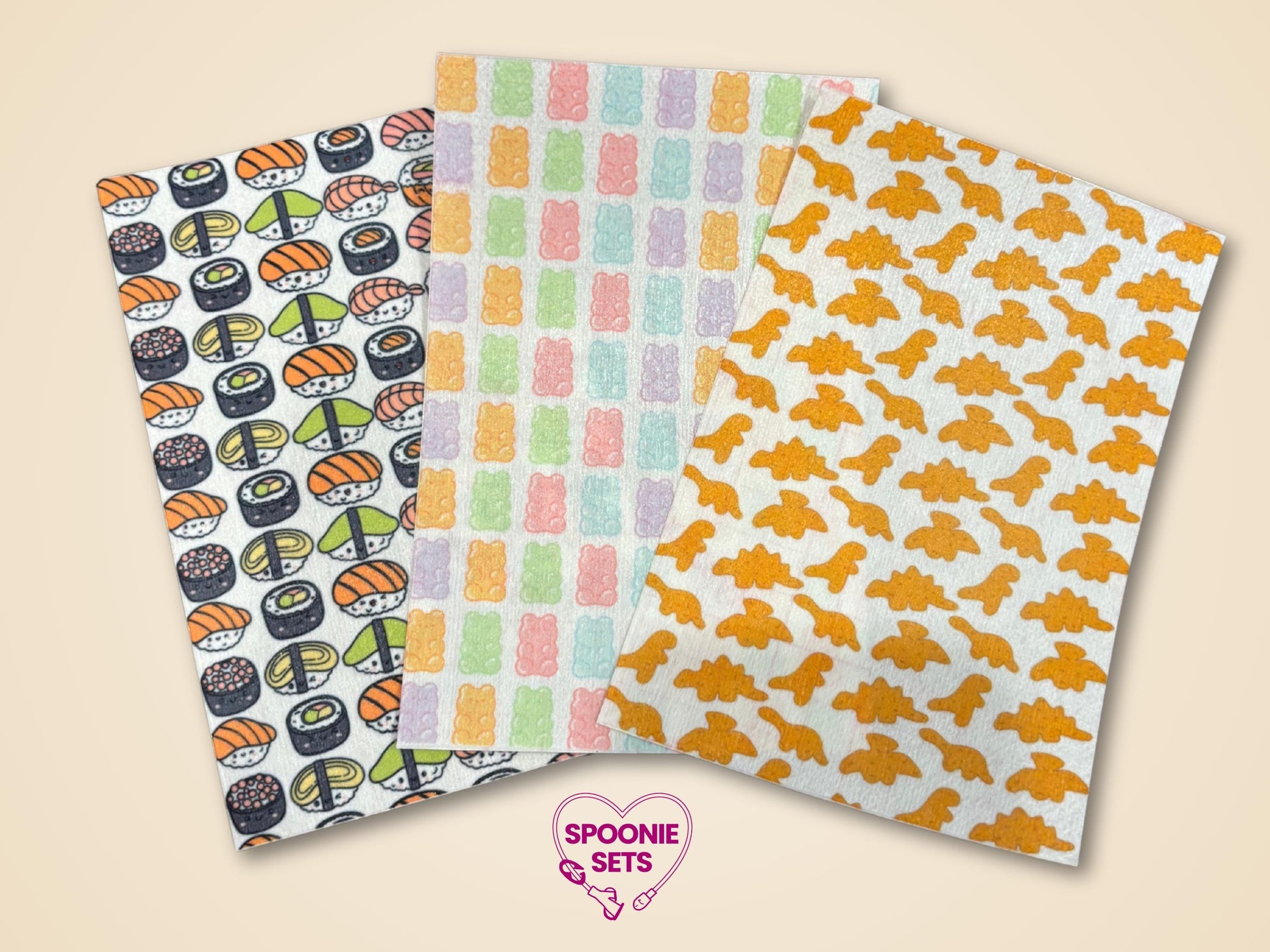 Three decorative Hypafix tubie tape sheets: sushi, colorful gummy bears, and orange dino nuggets.
