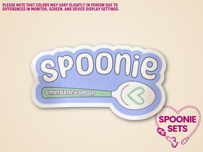 White and light blue "Spoonie" sticker with a green "emergency spoon" design and heart.