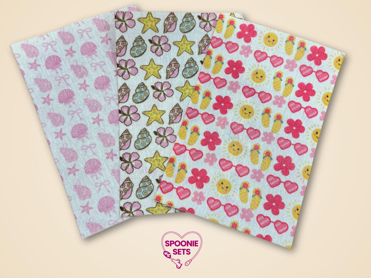 Three sheets of Hypafix tubie tape with summer designs: pink seashells, floral/seashells, and sun/flip-flops.