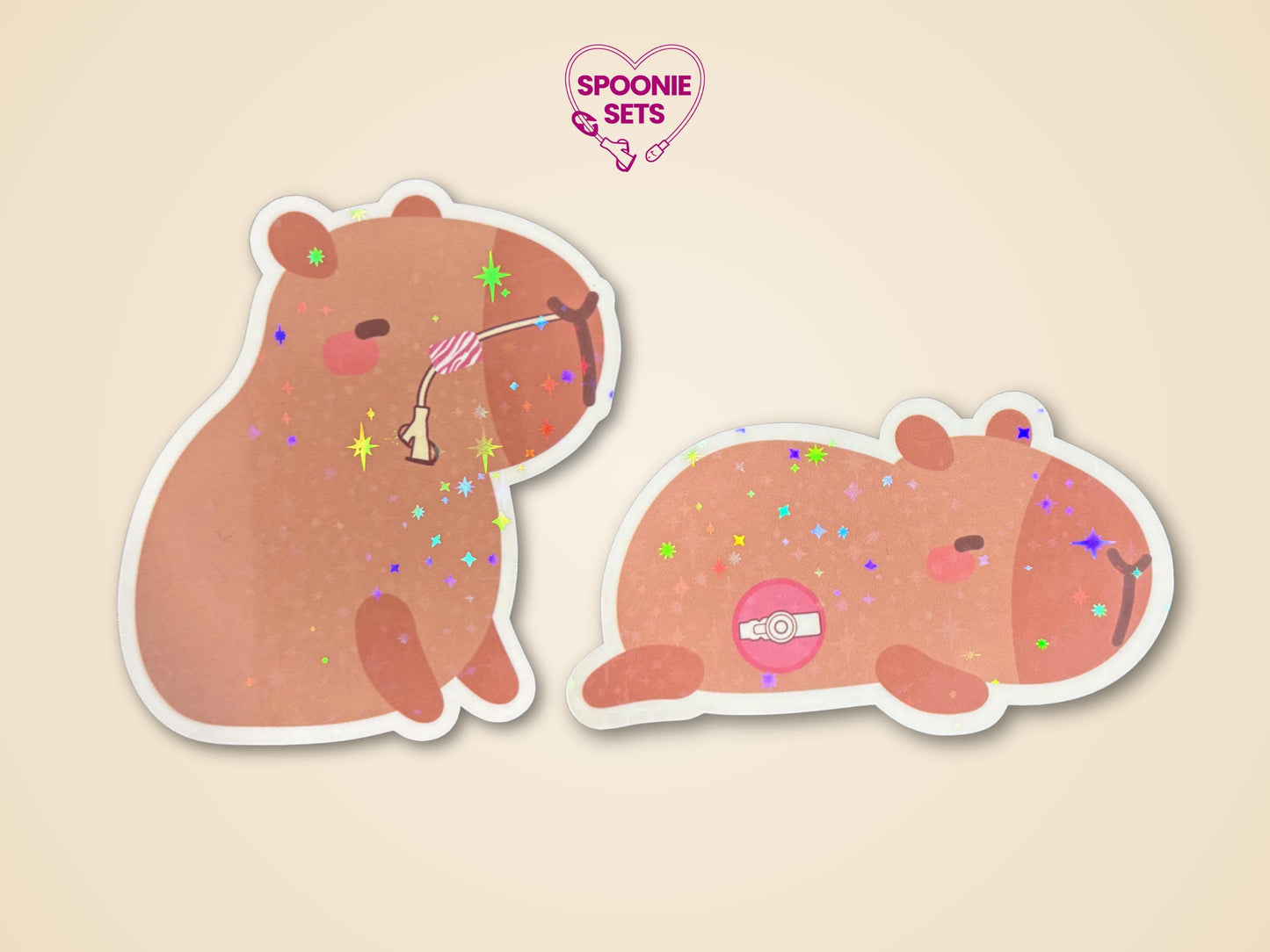 Two holographic glitter capybara stickers: one with an NG/NJ tube, one with a G/GJ/J tube.