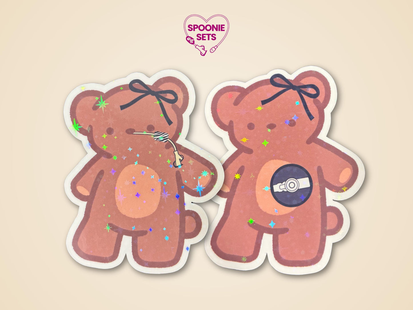 Two holographic glitter laminate stickers of brown teddy bears, one with a feeding tube, the other with a port.
